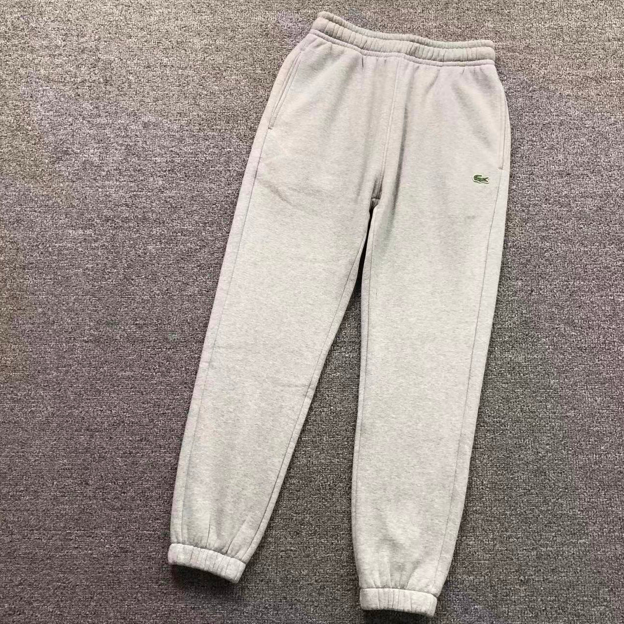 Gray sweatpants with a brand logo on a gray background